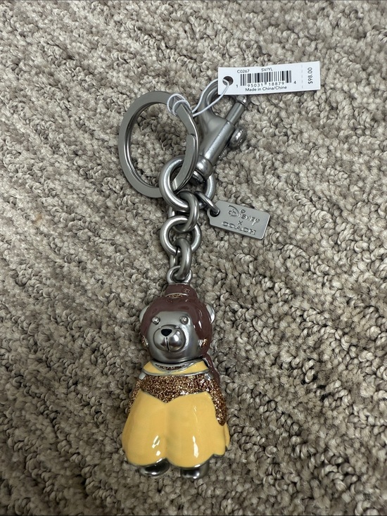Coach Accessories - Coach Disney X Princess Belle Bear Keychain in Yellow and Brown with Silver